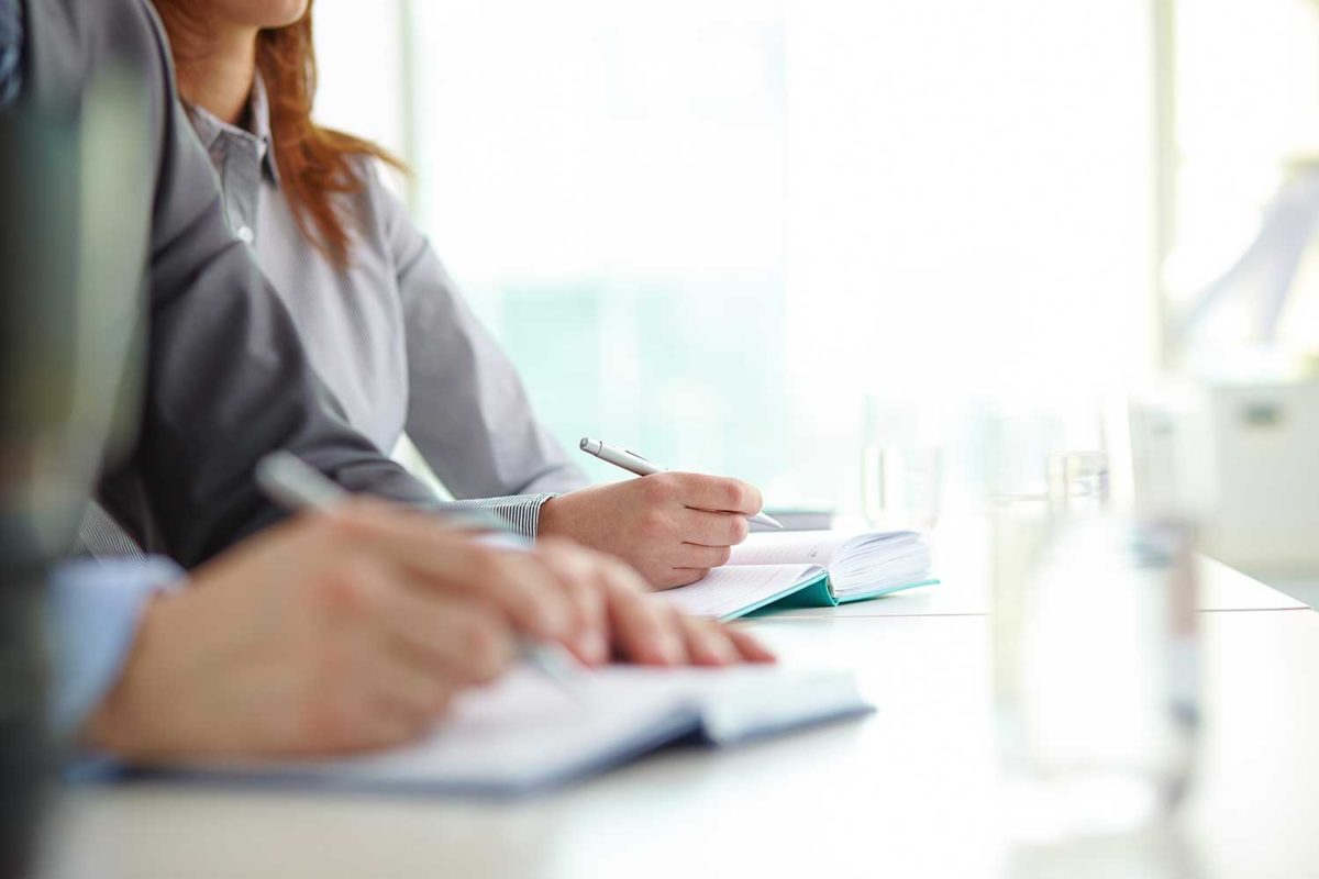 hands-close-up-co-workers-writing-1200x800.jpg